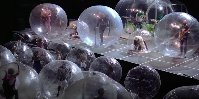 The Flaming Lips play in inflatable bubbles to audience in inflatable bubbles on ‘Colbert’